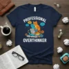 Professional Overthinker t-shirt design with a cat wearing glasses using a laptop on a stack of books