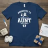 Promoted to Aunt Est. 2026 text with stork carrying baby design on a navy blue t-shirt