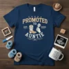 Promoted to Auntie Est. 2026 text with cowboy boot and magnifying glass graphic on navy t-shirt