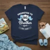 Promoted to Big Brother Again EST. 2026 t-shirt with cute blue dinosaurs and shield graphic