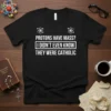 Black t-shirt with white text: "Protons Have Mass? I Didn't Even Know They Were Catholic" and atomic symbols