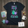 Proud Mom of 2 Cute Little Monsters text with green and purple cartoon monsters graphic on a navy t-shirt
