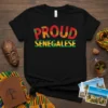 Proud Senegalese text design in red and green with African fabric pattern filling. Features Senegal flag colors