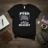 Black t-shirt with white text stating "PTSD It's Not A Personal Weakness Or A Disease It's An Injury" in a