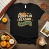 Black t-shirt with "Pumpkin Season Pumpkin Season" text and graphics, featuring pumpkins and floral accents