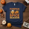 Pumpkin Spice Season t-shirt with cute cartoon pumpkin pie and coffee cup graphic, surrounded by fall leaves