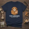Goldendoodle puppy reading a book with "Puppy Adventures" text on navy t-shirt, primary keyword: Puppy Adventures Goldendoodle Edition