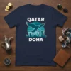 Qatar Doha t-shirt design with an eagle, city skyline, and sun graphic. White text reads QATAR and DOHA