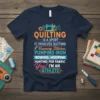Navy t-shirt with colorful text "Quilting Is A Sport It Involves Batting Running Stitches Pumping Iron Rowing Hooping Hunting For