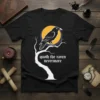 Black t-shirt with white text "quoth the raven nevermore" and a raven perched on a tree branch against a yellow