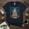 T-shirt featuring a cute raccoon sitting on blocks with text "RACCOON LIFE JUST A PHASE OF MINDS" and swirling lights