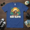Rad Sloth text design with a cartoon sloth skateboarding at sunset with palm trees