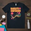 Radiate Confidence text with vibrant flowers and a silhouette figure on a black t-shirt