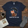 Rainy Day Cat Club t-shirt design featuring a cute red panda holding an umbrella in the rain