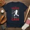 Raised in a Cage baseball training design featuring a batter silhouette in a batting cage, red text, and stars