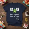 Navy t-shirt with text "Rare Legends Born on 2/29!" and a cartoon frog wearing a party hat, with calendar dates