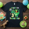 Green T-Rex dinosaur wearing sunglasses and a party hat, with text RAWR! I'M 3 THREE REX, balloons, and confetti