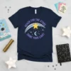 Navy t-shirt with purple text "Reach for the Stars Shine Your Light" and a celestial graphic including a star, moon