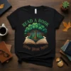 Read A Book Grow Your Mind t-shirt with a tree growing from an open book, green text, and forest graphic