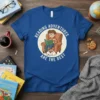 Reading Adventures Are The Best quote on a blue t-shirt with a boy reading in a chair and a dog