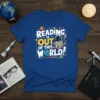 T-shirt with "Reading Is Out Of This World!" text, astronaut reading a book among planets and stars graphic