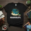 READSOLOTL text with a cute axolotl wearing glasses sitting on an open book, graphic t-shirt design
