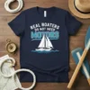Real Boaters Do Not Need Motors quote on a navy t-shirt with a white sailboat graphic