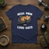 Real Men Love Cats T-Shirt design featuring a muscular arm holding a sleeping kitten, with bold white text