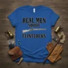 Blue t-shirt with "REAL MEN SHOOT FLINTLOCKS" text and a graphic of a flintlock rifle