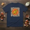 Navy t-shirt featuring the Reese's Peanut Butter Cups logo with a checkered background and the text "REESE'S CHOCOLATE PEANUT BUTTER