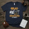 Navy t-shirt with text "RELAX THE GUITAR PLAYER IS HERE" and a graphic of an electric guitar and musical notes