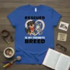 Rescued Is My Favorite Breed t-shirt with a cartoon dog and cat inside a heart, bold black text