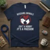 Rescuing Animals Isn't A Hobby It's A Passion text with dog and cat silhouette graphic on a navy t-shirt