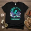 Black t-shirt with "resilience - strength not alone" text and a teal octopus illustration, surrounded by coral and starfish
