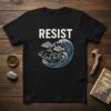 T-shirt with the word RESIST above a graphic of a fish with muscular arms swimming against a wave with two