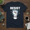 RESIST t-shirt design with a white clenched fist breaking chains and white rays against a light blue shield shape