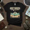 Retired Under New Managment t-shirt with vintage camper, campfire, and desert landscape. Features the phrase "You'll Find Me In My
