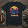 Retro graphic t-shirt featuring a howling coyote silhouette against a vibrant desert sunset and geometric design, with the word "COYOTE"