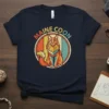 Retro styled Maine Coon cat graphic with "MAINE COON" text in a circle, vintage color palette, on a navy t-shirt