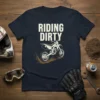 Riding Dirty text with a dirt bike illustration in mud splash on a navy blue t-shirt