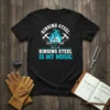 Black t-shirt with white and teal text "Ringing Steel Is My Music" and graphics of hammers, anvil, and musical treble