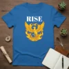 Blue t-shirt with white text "RISE" above a yellow and orange phoenix graphic in flames