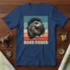 ROAR POWER t-shirt design with a fierce T-Rex bursting through a cracked background, vintage stripes, and bold text