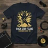 Rock Star Feline Shredding Since '69 text with a black cat playing guitar graphic on a navy t-shirt