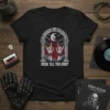 Black t-shirt with "Rock Till You Drop" text and skeleton hands graphic, featuring a gothic arch, moon, and clouds