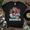 Rock and Roll Cat T-Shirt with a cat playing a red electric guitar and an amplifier