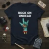 Rock On Undead text with a zombie hand making the rock and roll sign on a navy t-shirt