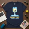 Rocket Fuel Powered By Dreams t-shirt with a rocket launching through clouds. Motivational quote in bold lettering