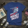 ROCKET SKATE! text on a t-shirt with a robot skateboarding, red, white, and blue patriotic background
