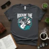 Rockin' The Life t-shirt with white electric guitar, music notes, and dove graphic on a dark heather tee